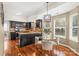 Eat in kitchen area featuring dark cabinetry, a granite countertop, and stainless steel appliances at 13010 Indian Hills Ln, Charlotte, NC 28278