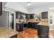 Well-equipped kitchen with dark cabinets, granite countertops, and stainless steel appliances at 13010 Indian Hills Ln, Charlotte, NC 28278