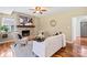 Comfortable living room with hardwood floors, a stone fireplace, and neutral-toned furnishings at 13010 Indian Hills Ln, Charlotte, NC 28278