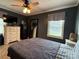 Calm bedroom with ceiling fan, dark walls, carpet, dresser and window with natural light at 1314 Hathcock Ave, Albemarle, NC 28001