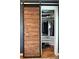 The wood sliding door is open to expose an organized closet with rods, shelves, and shoes at 1314 Hathcock Ave, Albemarle, NC 28001