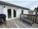 Back deck with grill, chair, and french doors at 1314 Hathcock Ave, Albemarle, NC 28001