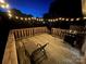Wooden deck with string lights, lounge chair, and grill, perfect for outdoor relaxation and entertainment at 1314 Hathcock Ave, Albemarle, NC 28001