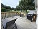 Relax on this wooden deck, featuring a grill, a chair, and stairs down to the yard at 1314 Hathcock Ave, Albemarle, NC 28001