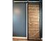 A view of the wood and metal sliding door which has a black handle and the wall is a dark gray at 1314 Hathcock Ave, Albemarle, NC 28001