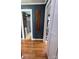 A shot down a hallway with hardwood floors leading to a bathroom and another room at 1314 Hathcock Ave, Albemarle, NC 28001
