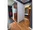 Hallway with access to bedrooms featuring hardwood flooring and freshly painted trim and walls at 1314 Hathcock Ave, Albemarle, NC 28001