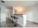 Chic bar area with two stools, decorative molding, and dark wood floors at 1315 East Blvd # 327, Charlotte, NC 28203