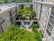 A beautiful courtyard in the complex features lush landscaping, a unique water feature, and several trees at 1315 East Blvd # 327, Charlotte, NC 28203