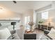 Modern living room with gray sofa, bar seating area, and sliding doors to balcony at 1315 East Blvd # 327, Charlotte, NC 28203