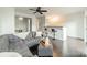 Bright living room with a ceiling fan, grey couch, dark floors, and a stylish breakfast bar at 1315 East Blvd # 327, Charlotte, NC 28203