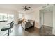 Open living room featuring sleek hardwood floors, modern ceiling fan, and a cozy gray sofa at 1315 East Blvd # 327, Charlotte, NC 28203