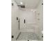 Shower with black fixtures, rainfall shower head, built-in niche, and geometric floor tiles at 1315 East Blvd # 327, Charlotte, NC 28203