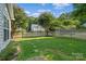 Spacious fenced backyard, lush green lawn, landscaping, and a stone pathway at 15280 Leslie Brook Rd, Huntersville, NC 28078