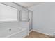Bright bathroom showcasing a bathtub and separate shower at 15280 Leslie Brook Rd, Huntersville, NC 28078