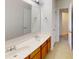 Bathroom featuring a double sink vanity with wooden cabinets and a large mirror at 15280 Leslie Brook Rd, Huntersville, NC 28078