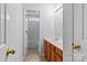 Bathroom featuring double sinks with wooden cabinets and a tiled floor at 15280 Leslie Brook Rd, Huntersville, NC 28078