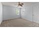 Bedroom with neutral carpeting, ceiling fan, and natural light from two windows at 15280 Leslie Brook Rd, Huntersville, NC 28078