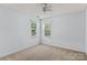 Bedroom with neutral carpeting and natural light from two windows at 15280 Leslie Brook Rd, Huntersville, NC 28078