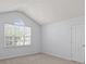 Bright, carpeted bedroom with vaulted ceiling and large window at 15280 Leslie Brook Rd, Huntersville, NC 28078