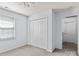 Bedroom with neutral carpeting, closet with bi-fold doors, and natural light from one window at 15280 Leslie Brook Rd, Huntersville, NC 28078