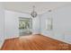Elegant dining area featuring modern lighting, neutral walls, and views of the backyard at 15280 Leslie Brook Rd, Huntersville, NC 28078