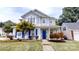 Charming two-story home featuring a blue front door, well-manicured lawn, and beautiful landscaping at 15280 Leslie Brook Rd, Huntersville, NC 28078