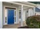 Welcoming front entrance with a bright blue door and sidelights, creating curb appeal at 15280 Leslie Brook Rd, Huntersville, NC 28078