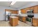 Spacious kitchen with island, stainless steel appliances, and ample cabinet space at 15280 Leslie Brook Rd, Huntersville, NC 28078