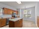 Bright kitchen with an island, stainless steel appliances, and wood cabinetry at 15280 Leslie Brook Rd, Huntersville, NC 28078