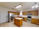 Kitchen features stainless steel appliances, wooden cabinetry, and a central island at 15280 Leslie Brook Rd, Huntersville, NC 28078