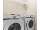 Laundry area with Samsung washer and dryer and wire rack shelving for storage at 15280 Leslie Brook Rd, Huntersville, NC 28078