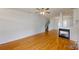 Spacious living room with hardwood floors, fireplace, and staircase at 15280 Leslie Brook Rd, Huntersville, NC 28078