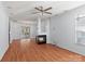 Spacious living room with hardwood floors, fireplace, and ample natural light from large windows at 15280 Leslie Brook Rd, Huntersville, NC 28078