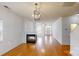 Open living room with fireplace, hardwood floors, and lots of natural light at 15280 Leslie Brook Rd, Huntersville, NC 28078