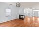 Open-concept living room with modern fireplace, hardwood floors, and a stylish chandelier at 15280 Leslie Brook Rd, Huntersville, NC 28078