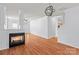 Open floor plan with fireplace, wood flooring, and access to other rooms and the backyard at 15280 Leslie Brook Rd, Huntersville, NC 28078