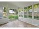 Sunroom with sliding glass door providing access to the fenced back yard at 15280 Leslie Brook Rd, Huntersville, NC 28078