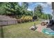Well-maintained backyard with a black metal fence, patio set, and a basketball hoop, perfect for outdoor fun at 15636 Oleander Dr, Charlotte, NC 28278