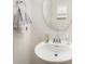 Clean bathroom with pedestal sink, oval mirror, and crisp white color palette at 15636 Oleander Dr, Charlotte, NC 28278