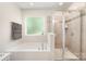 Bathroom featuring a soaking tub with window view and a tiled glass-enclosed shower at 15636 Oleander Dr, Charlotte, NC 28278