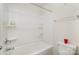 Clean, white bathroom featuring a shower and tub with built-in shelving for bath products at 15636 Oleander Dr, Charlotte, NC 28278