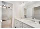 Bright bathroom with double vanity and a walk-in closet at 15636 Oleander Dr, Charlotte, NC 28278