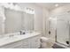 Bright bathroom with a double sink vanity, a framed mirror, and a glass-enclosed shower at 15636 Oleander Dr, Charlotte, NC 28278