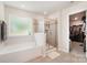 Bathroom featuring a soaking tub, shower, and walk-in closet at 15636 Oleander Dr, Charlotte, NC 28278