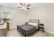 Bedroom featuring light wood floors, a patterned black and white comforter and natural light from a window at 15636 Oleander Dr, Charlotte, NC 28278