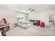 Large bonus room with a ceiling fan, plush carpet, and ample natural light, perfect for relaxing at 15636 Oleander Dr, Charlotte, NC 28278
