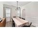 Dining room features neutral walls, modern lighting, and a large table that is perfect for hosting dinner parties at 15636 Oleander Dr, Charlotte, NC 28278