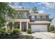 Charming two-story brick home featuring a covered front porch and a two-car garage at 15636 Oleander Dr, Charlotte, NC 28278