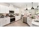 Modern kitchen with white cabinets, stainless steel appliances, and granite countertops at 15636 Oleander Dr, Charlotte, NC 28278